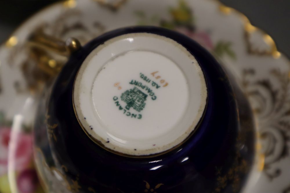 A Royal Crown Derby teacup, a saucer and a tea plate,